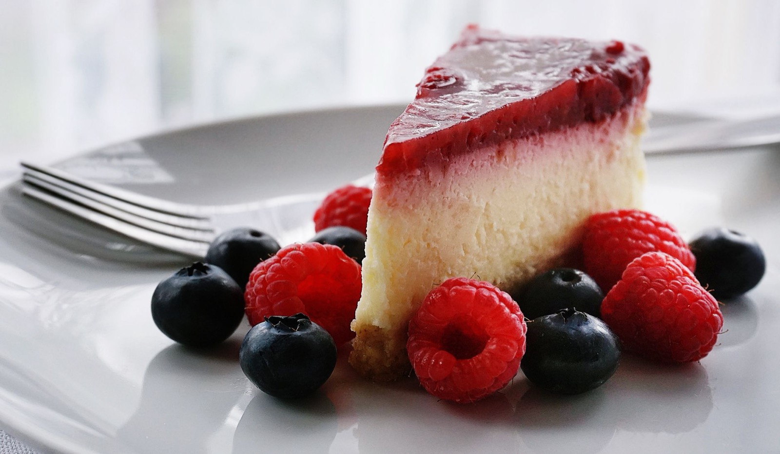 Slice of cheesecake topped with berries