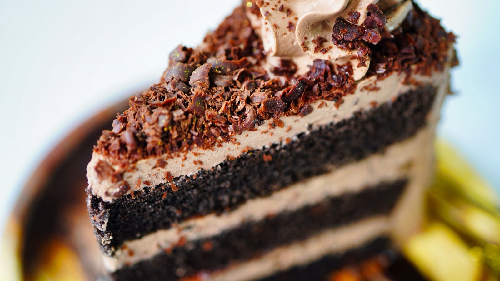Slice of chocolate layer cake with rich frosting